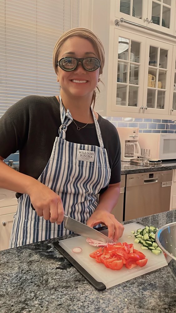 Kina cooking in her home kitchen, preparing fresh ingredients by hand