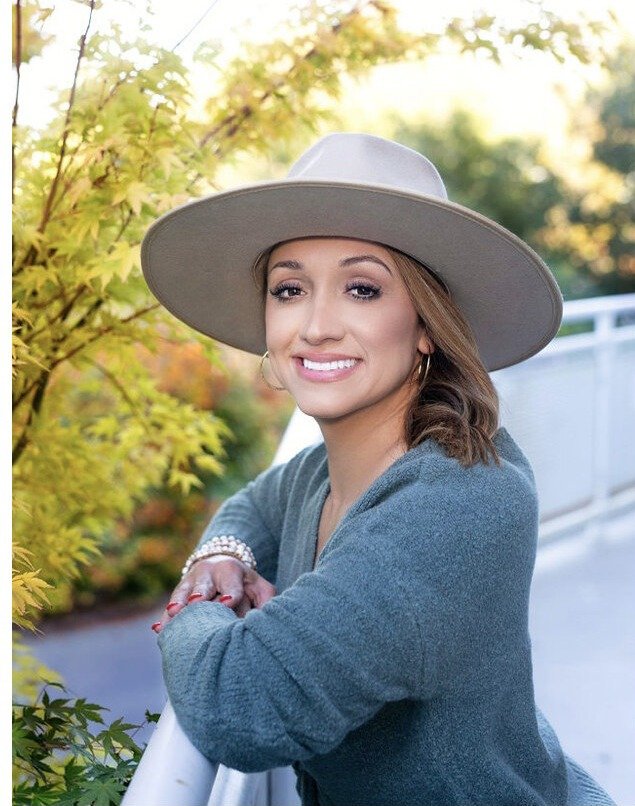 Kina smiling warmly outdoors