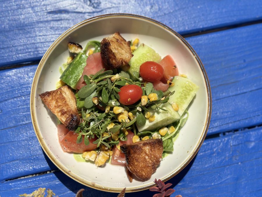 Fresh family-sized salad with tomato and greens