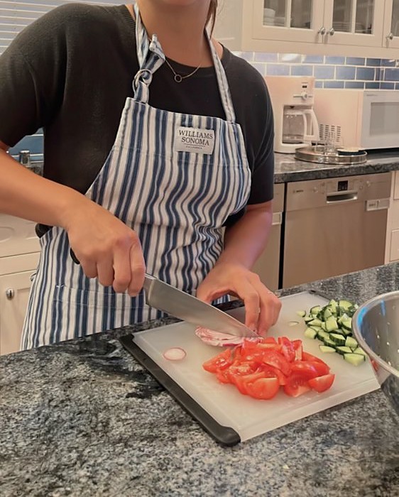 Kina&rsquo;s hands preparing fresh ingredients on a cutting board